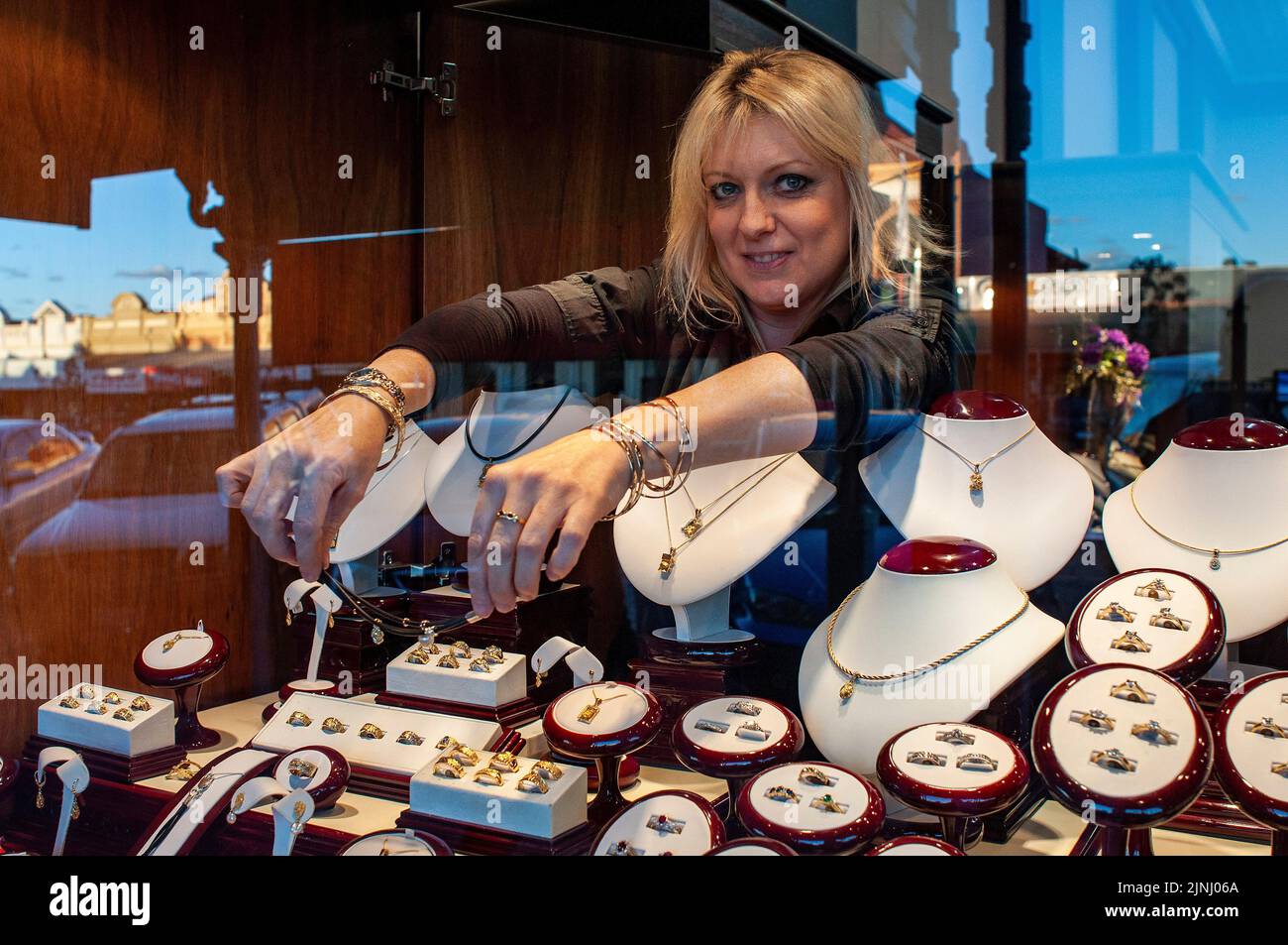A shop assistant arranging the window of a jewellers in Kalgoorlie, Western Australia Stock Photo