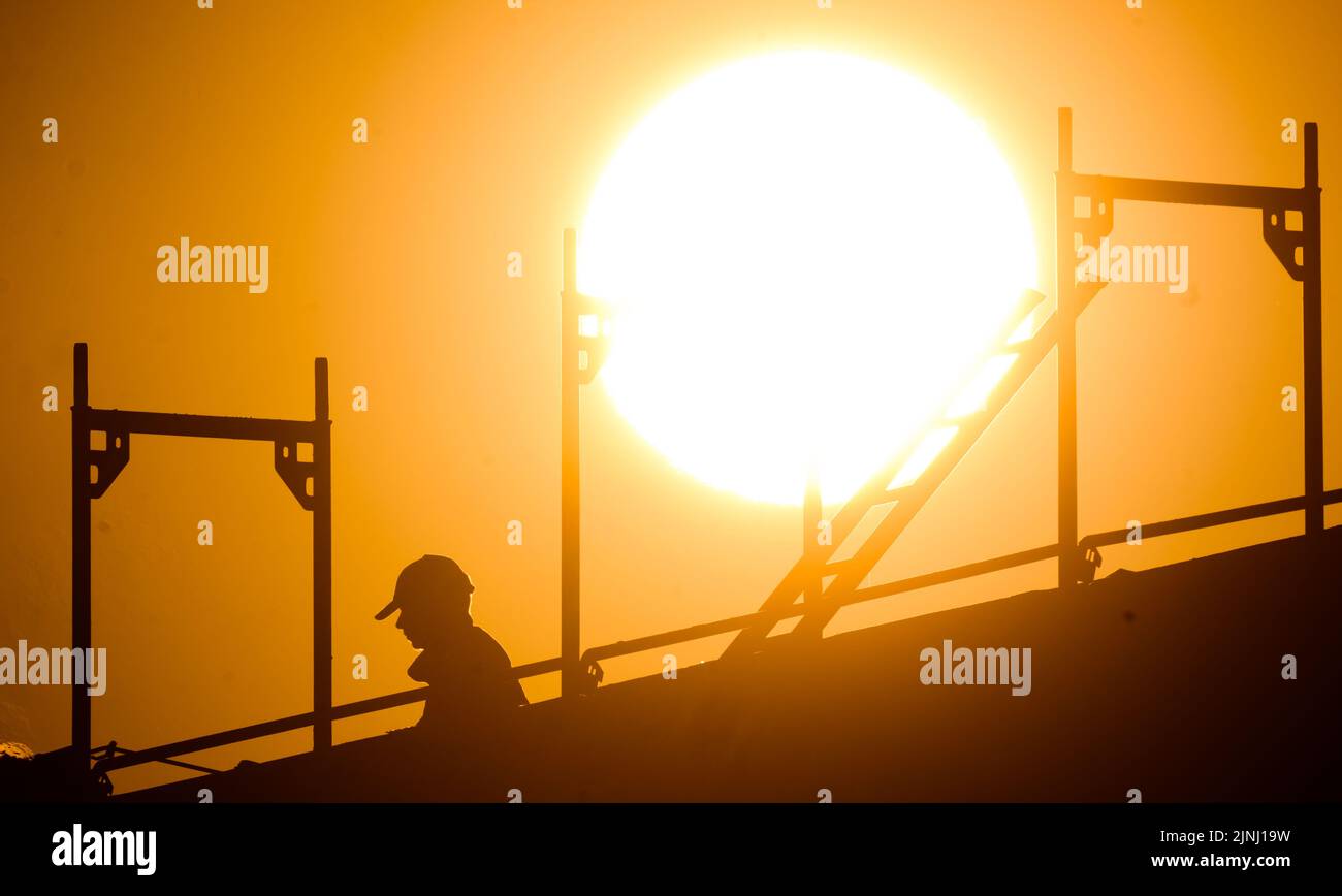 Hanover, Germany. 12th Aug, 2022. A construction worker stands building