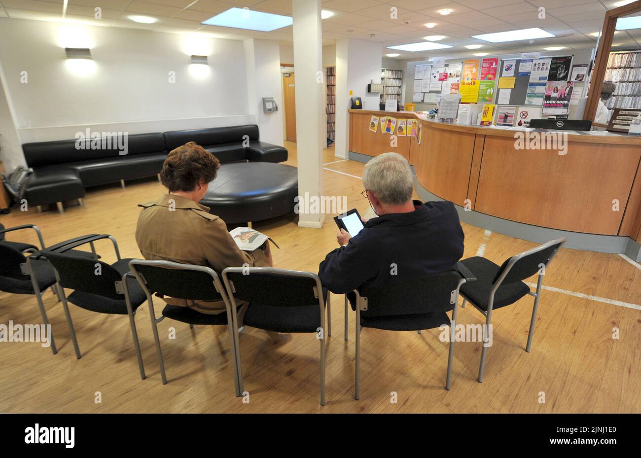 File photo dated 10/09/14 of patients sitting in the waiting room of a GP Practice near Golders Green, London, as children will face longer waits for help with autism or speech problems due to NHS staff shortages outside of hospitals, health leaders have warned. Stock Photo