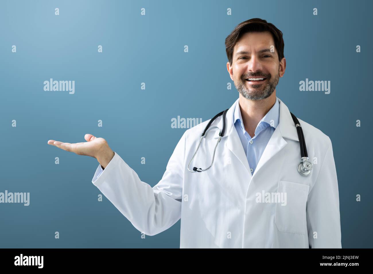 Happy Man Doctor In Labcoat Standing And Gesturing Stock Photo