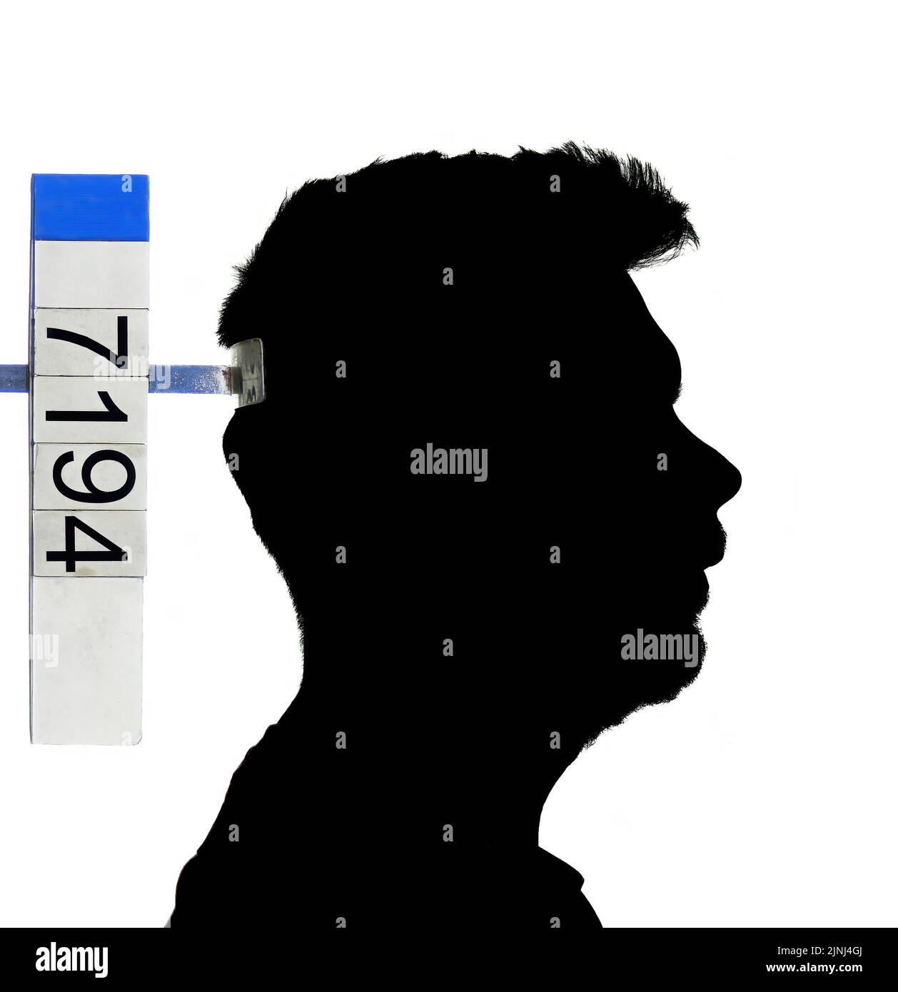 A profile view silhouette, in black, of a unrecognizable criminal, male, being booked by the police. Blank background, copy space. Concept of crime an Stock Photo