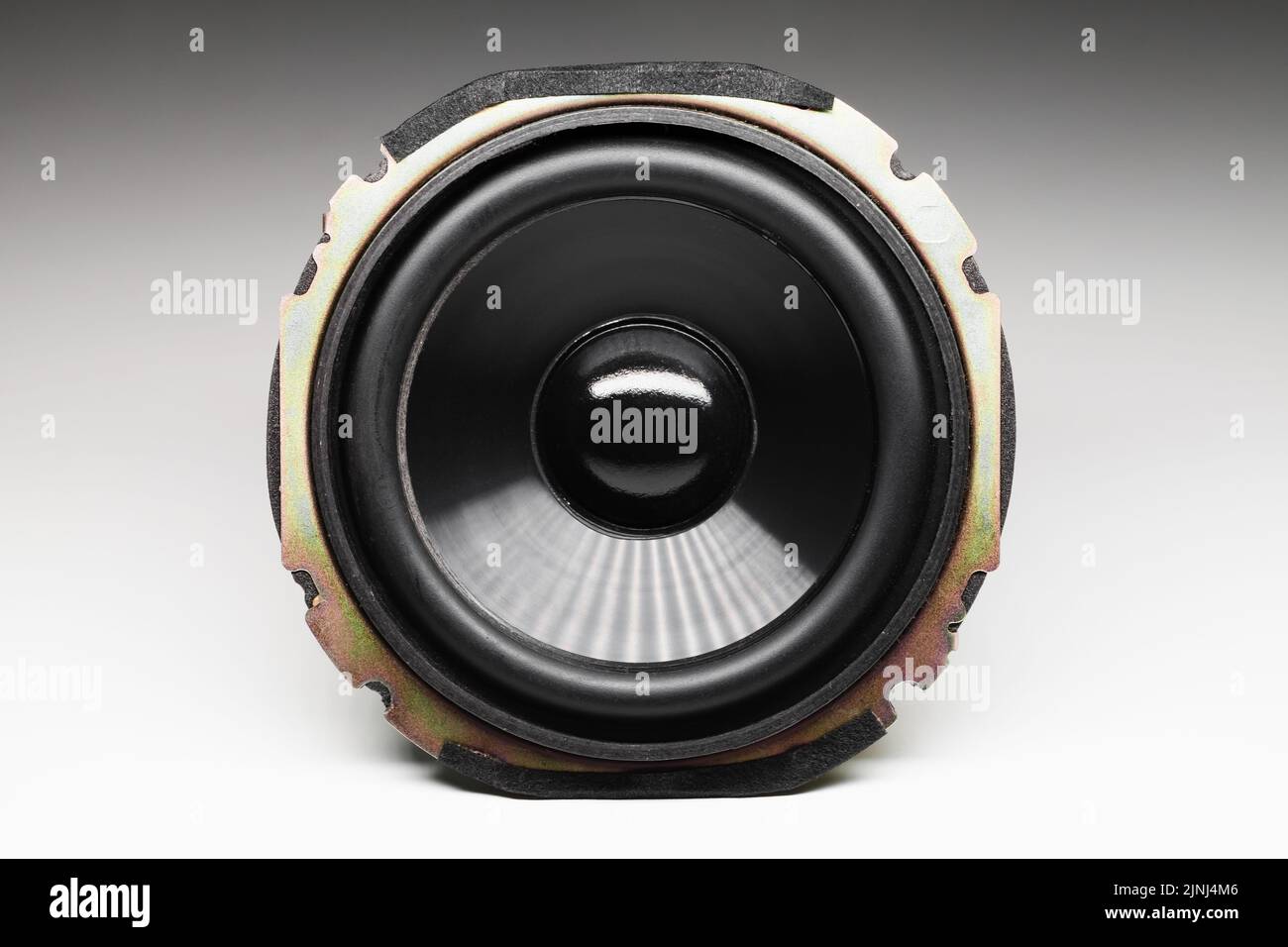 Shiny black audio speaker is on a white background with soft shadow, Hi-Fi audio system component, close-up photo, front view Stock Photo
