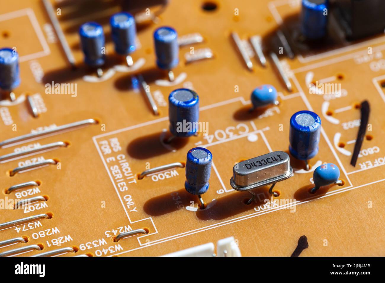 Printed circuit board with capacitors, close up photo with selective soft focus Stock Photo