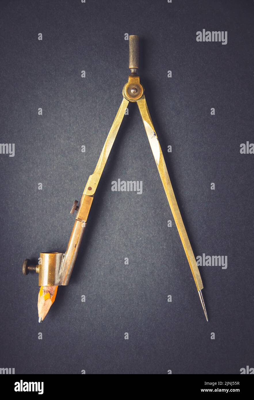 Old vintage pair of compasses on a dark background Stock Photo
