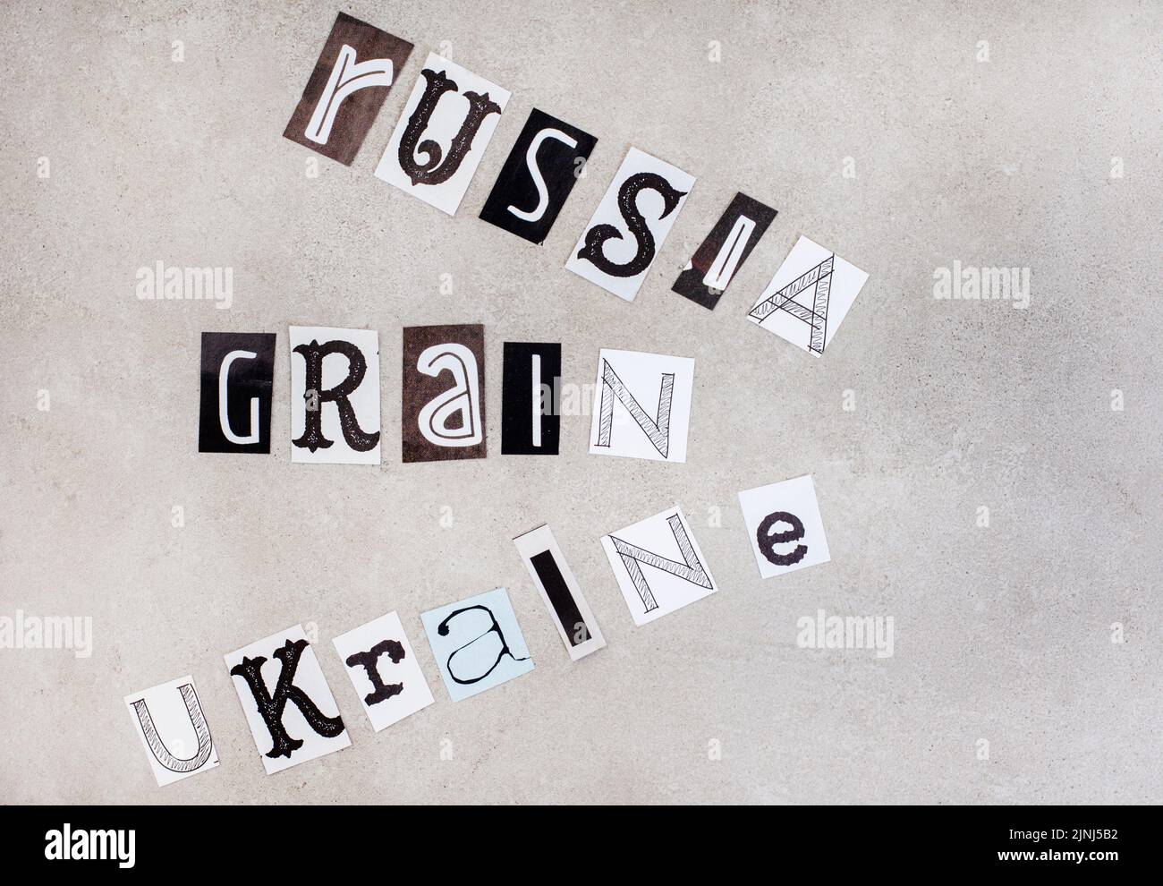Russia, Ukraine and war, social issues surrounding it in magazine clippings on grey Stock Photo