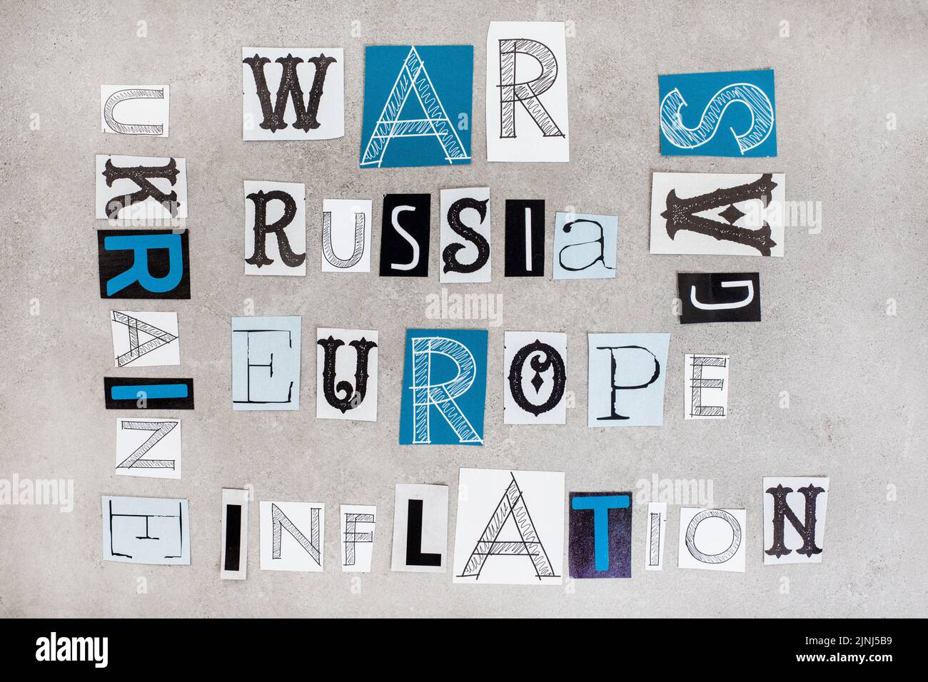 Russia, Ukraine and war, social issues surrounding it in magazine clippings on grey Stock Photo
