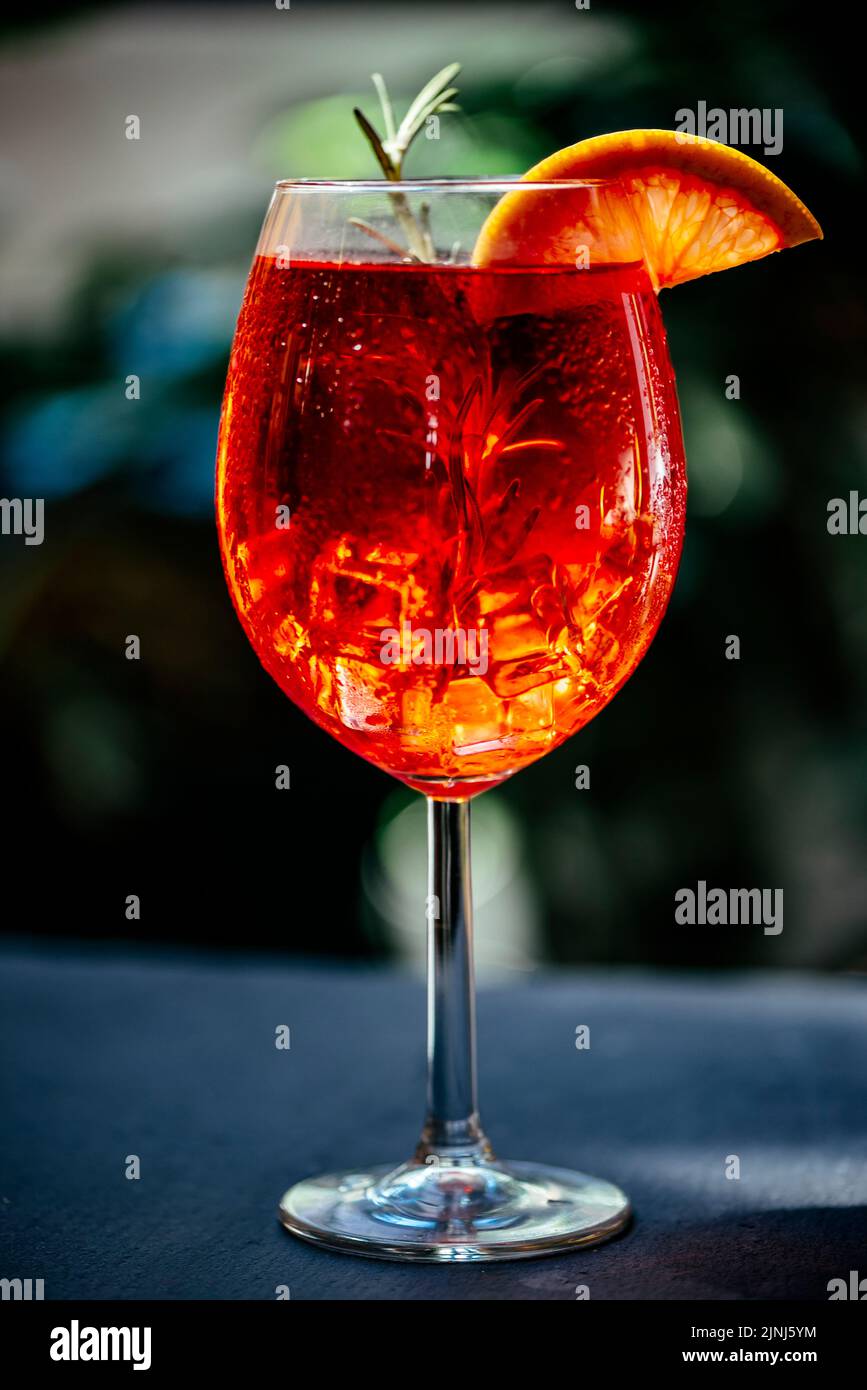 Aperol spritz cocktail garnish with grapefruit and rosemary in front of