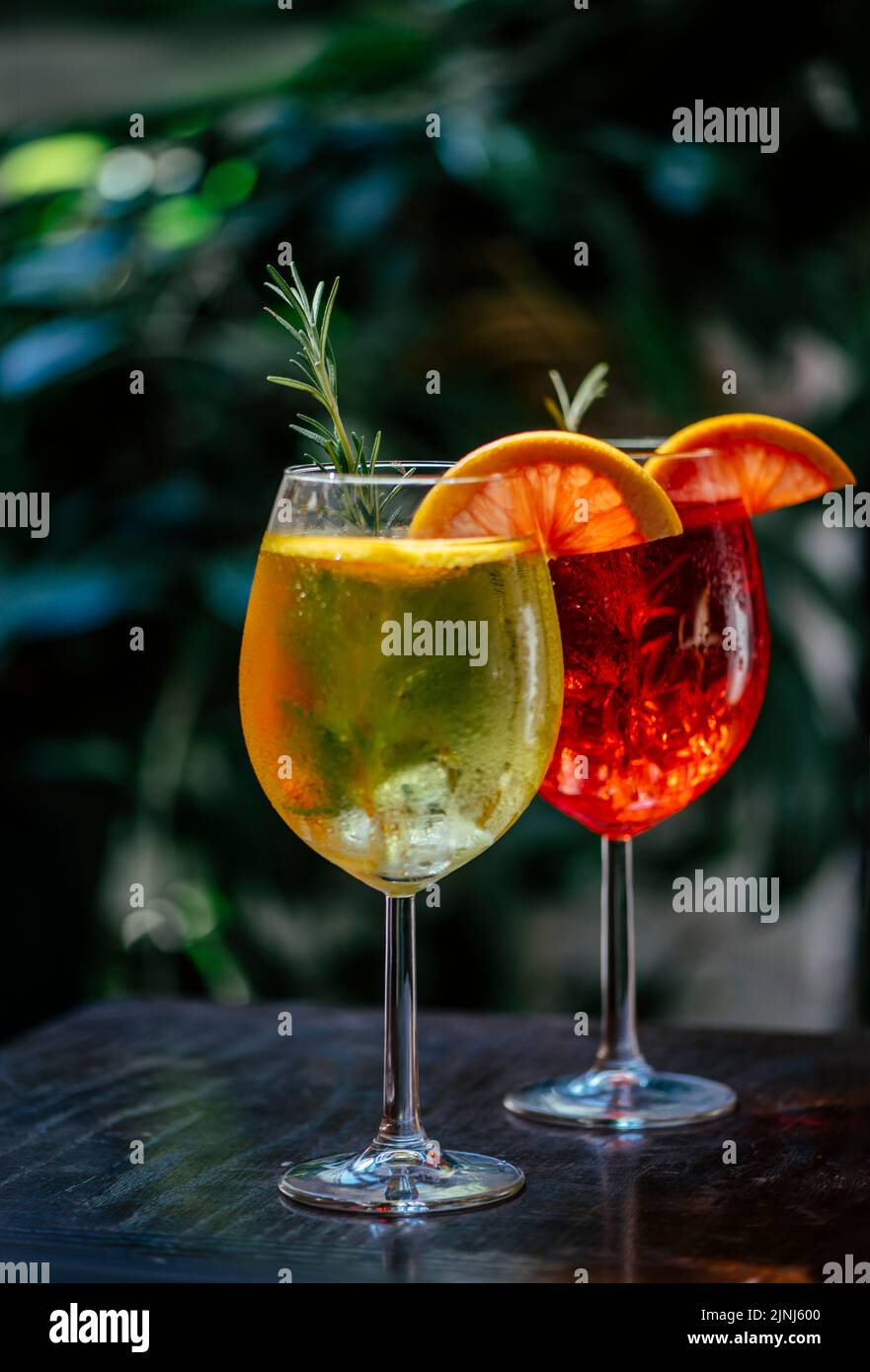 Aperol spritz cocktail garnish with grapefruit and rosemary in front of