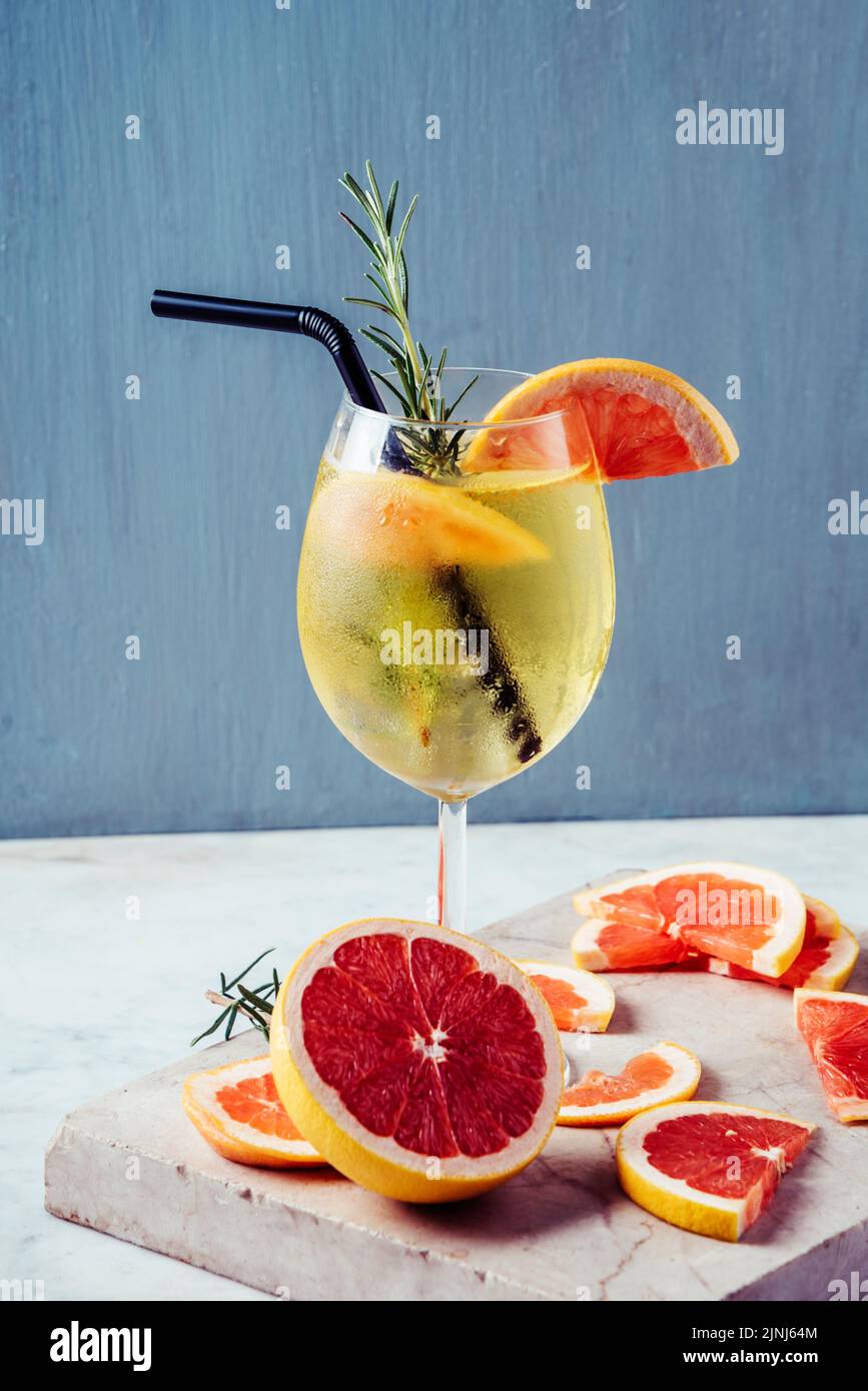 Aperol spritz garnish in wine glasses with rosemary and grapefruit on