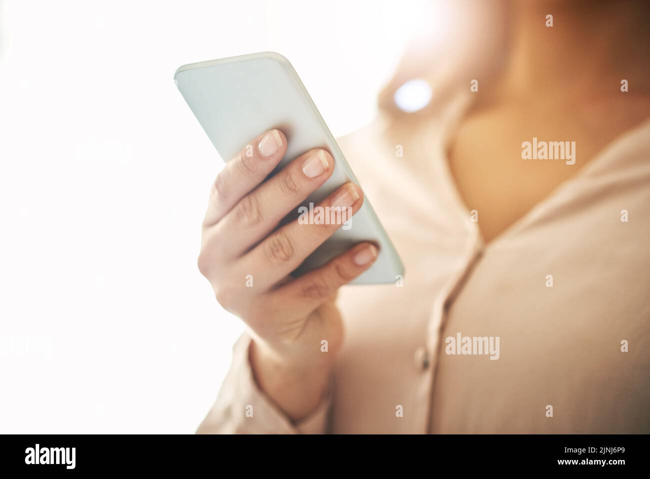 Phone in hand, communication and networking with a woman reading, typing or sending a text message. Closeup of a female browsing social media, surfing Stock Photo