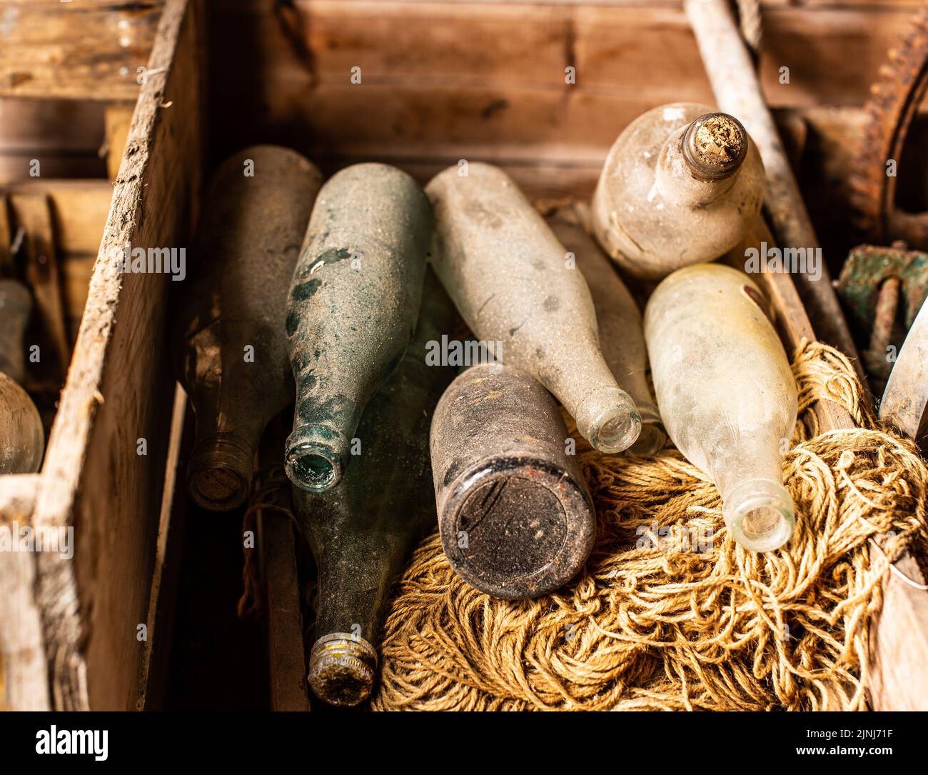 A closeup shot of dusty antique glass bottles in a box Stock Photo