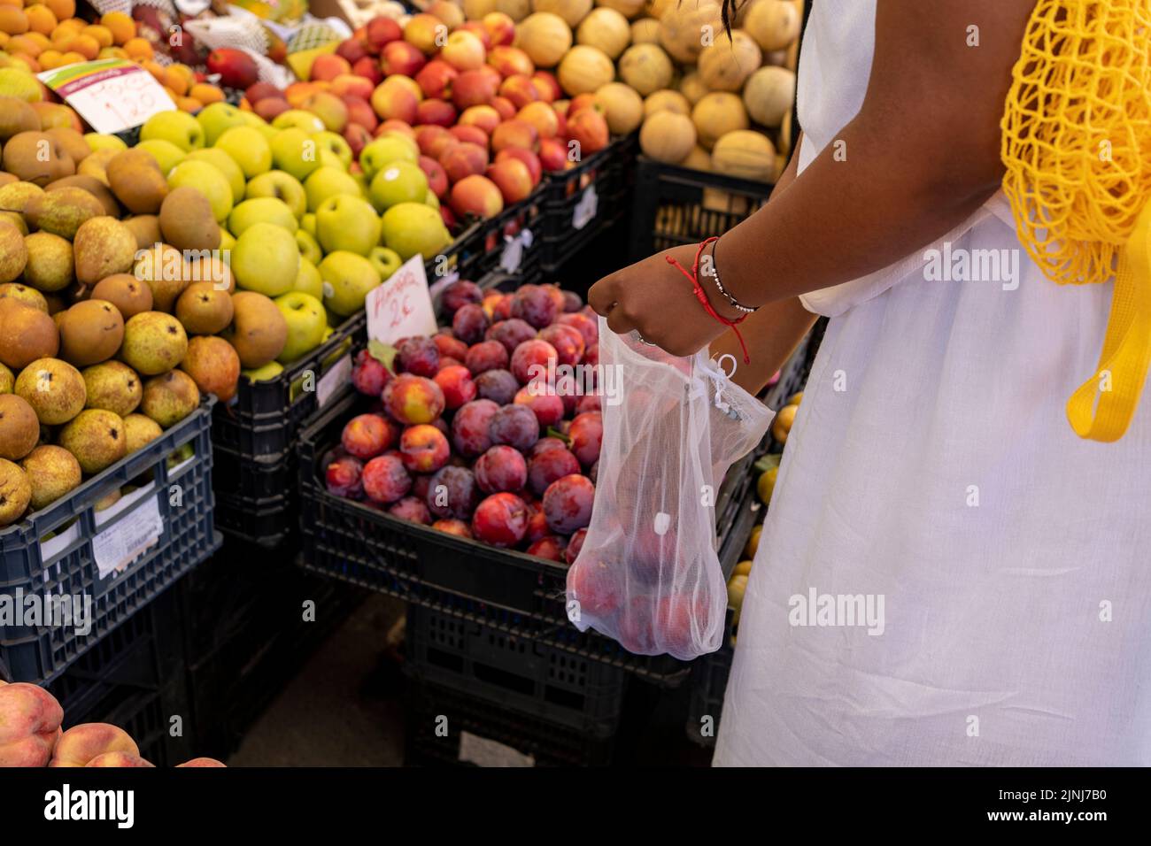 Woman chooses fruits and vegetables at farmers market,  of zero waste concept. Stock Photo
