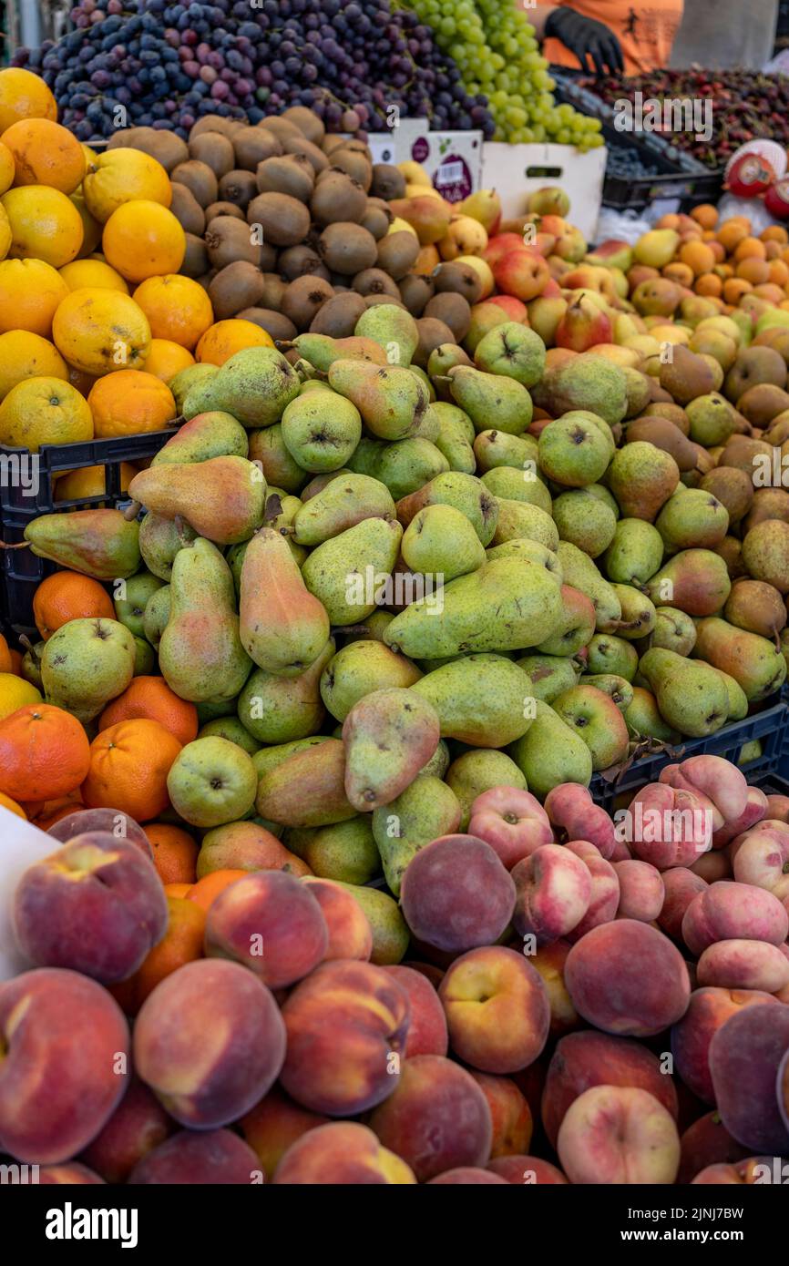 Variety of fresh fruit in crates at an open-air farmers' market Stock Photo