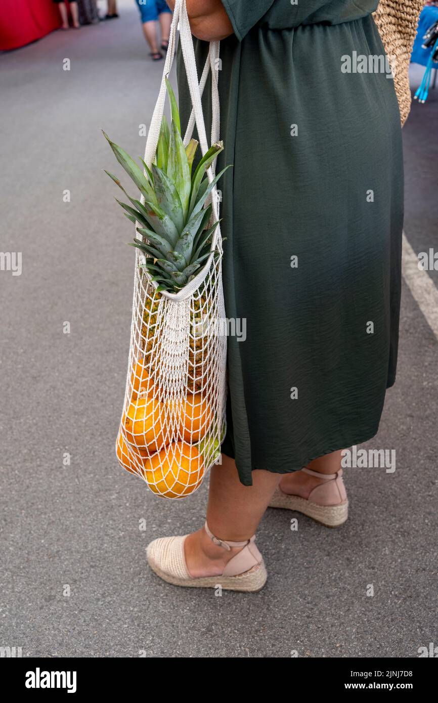 Woman chooses fruits and vegetables at farmers market,  Sustainable lifestyle with zero waste and plastic free shopping concept Stock Photo