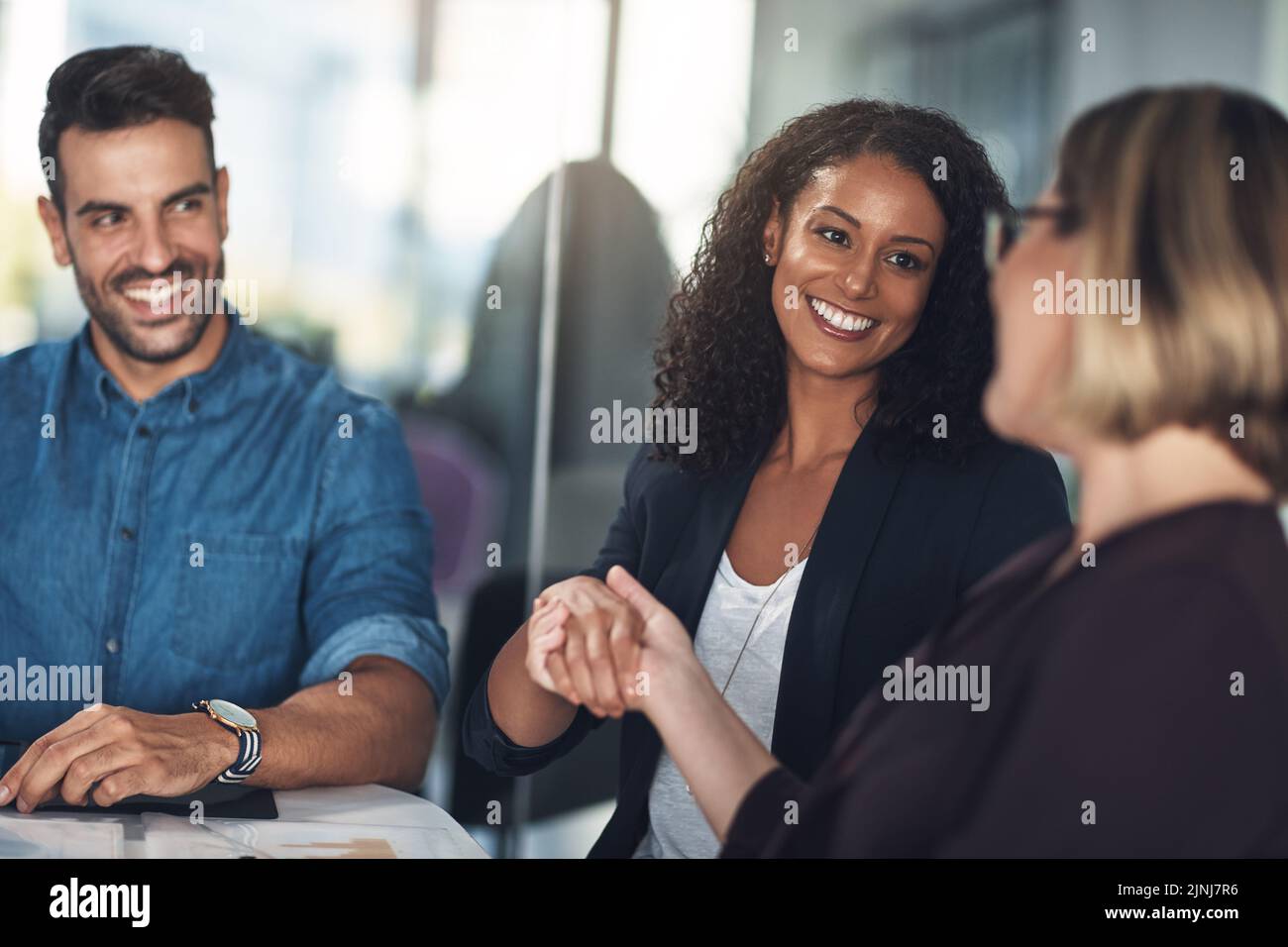 Handshake, collaboration and business deal while introducing, congratulating and wishing a colleague good luck for leadership promotion. Diverse Stock Photo