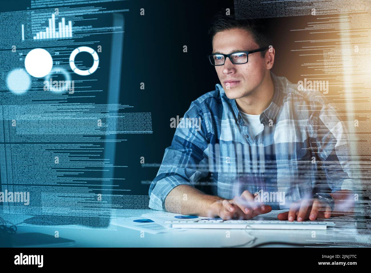 Male it computer worker working on a future hologram cgi screen at his office desk. Tech designer using technology to test new, abstract and Stock Photo