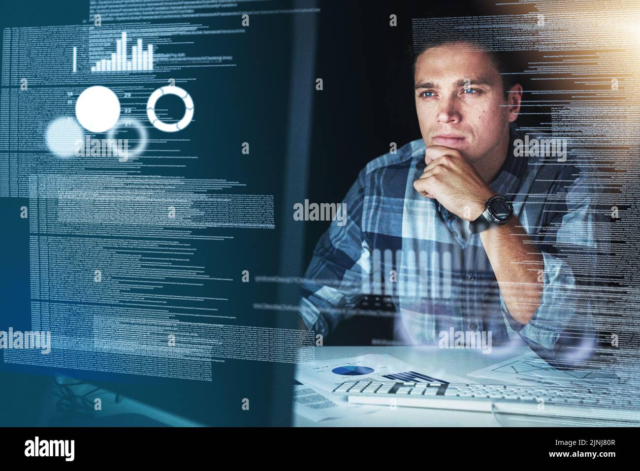 Computer programmer, software developer, or engineer working on computer database with futuristic CGI graphic data. Male information technology coder Stock Photo