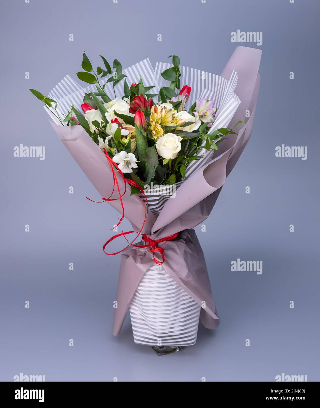 Flower bouquet, which is wrapped in light floral paper of two types