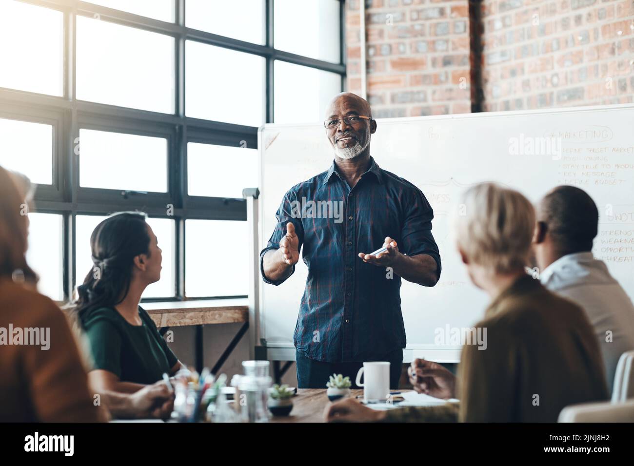 Senior business man doing presentation, planning and talking in a meeting, seminar or training workshop in a boardroom. Manager sharing ideas Stock Photo