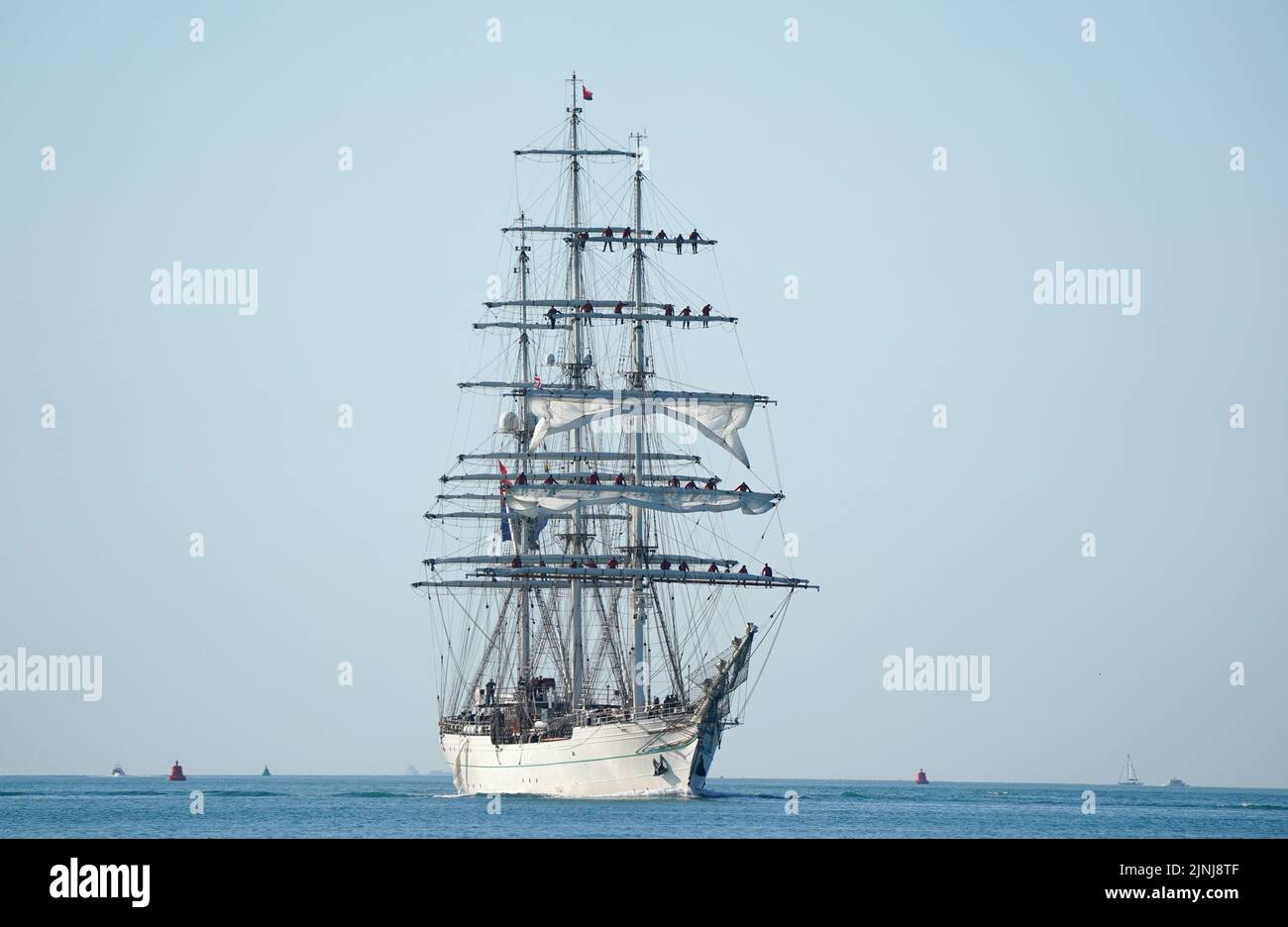 The vessel Shabab Oman II, a full-rigged training ship of the Royal Navy of Oman, arrives into Portsmouth Harbour. The ship is a blend of the traditional and modern with state of the art computerised communication systems and navigation equipment, but from the wooden decking upwards, the ship is traditional in terms of her sails and rigging. Picture date: Friday August 12, 2022. Stock Photo