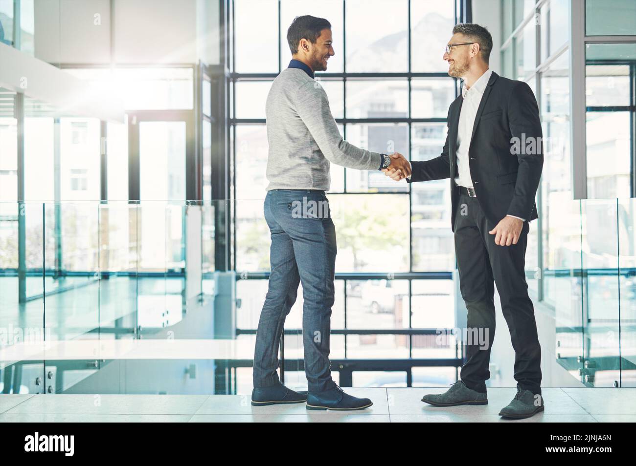 Handshake, teamwork and working together with corporate business men and colleagues at work as a team. Making a deal during a meeting, greeting and Stock Photo