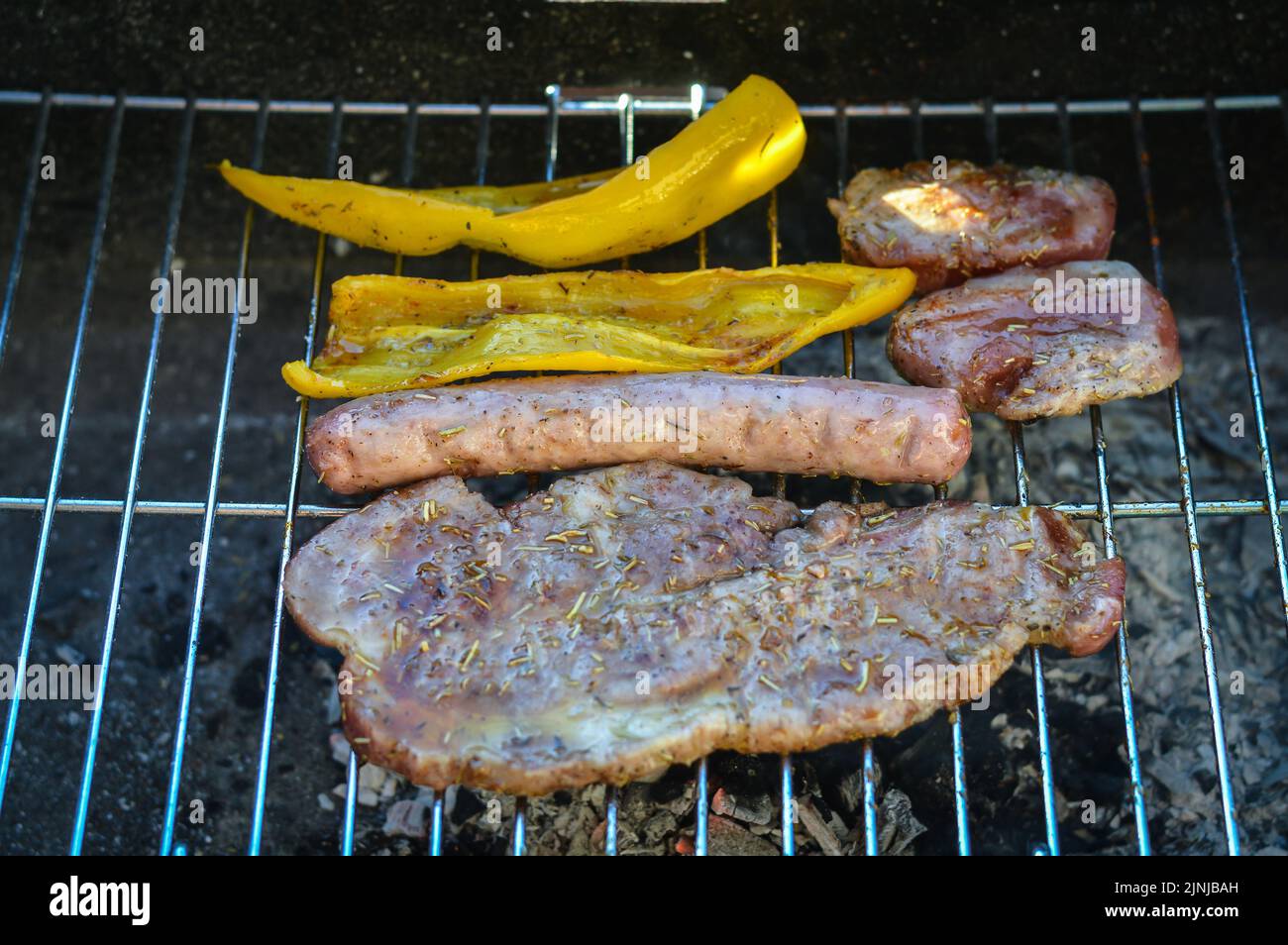 barbecue with pork and peppers that cook slowly with no flame and a