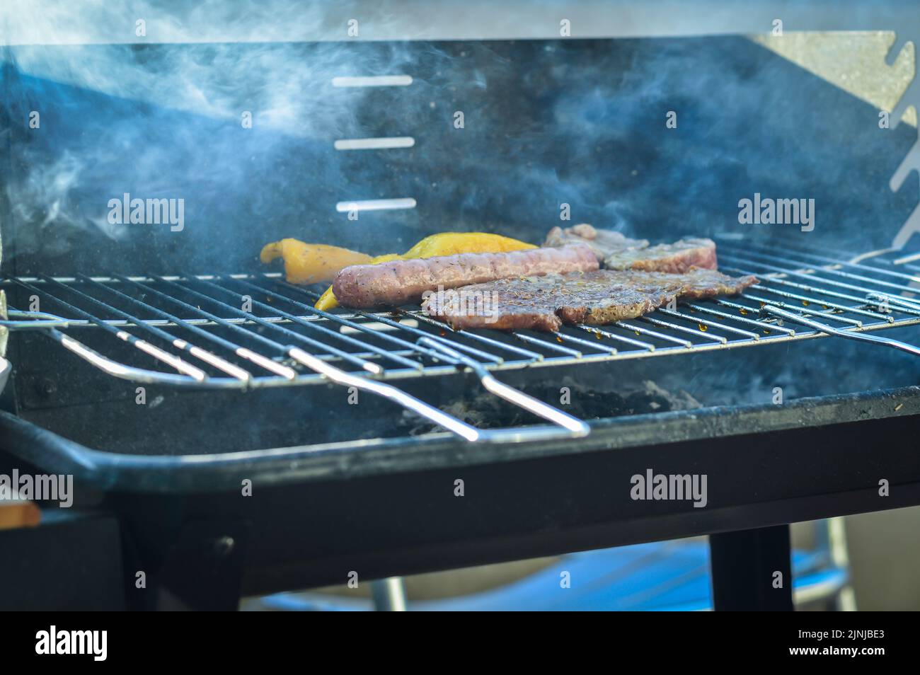 barbecue with pork and peppers that cook slowly with no flame and a