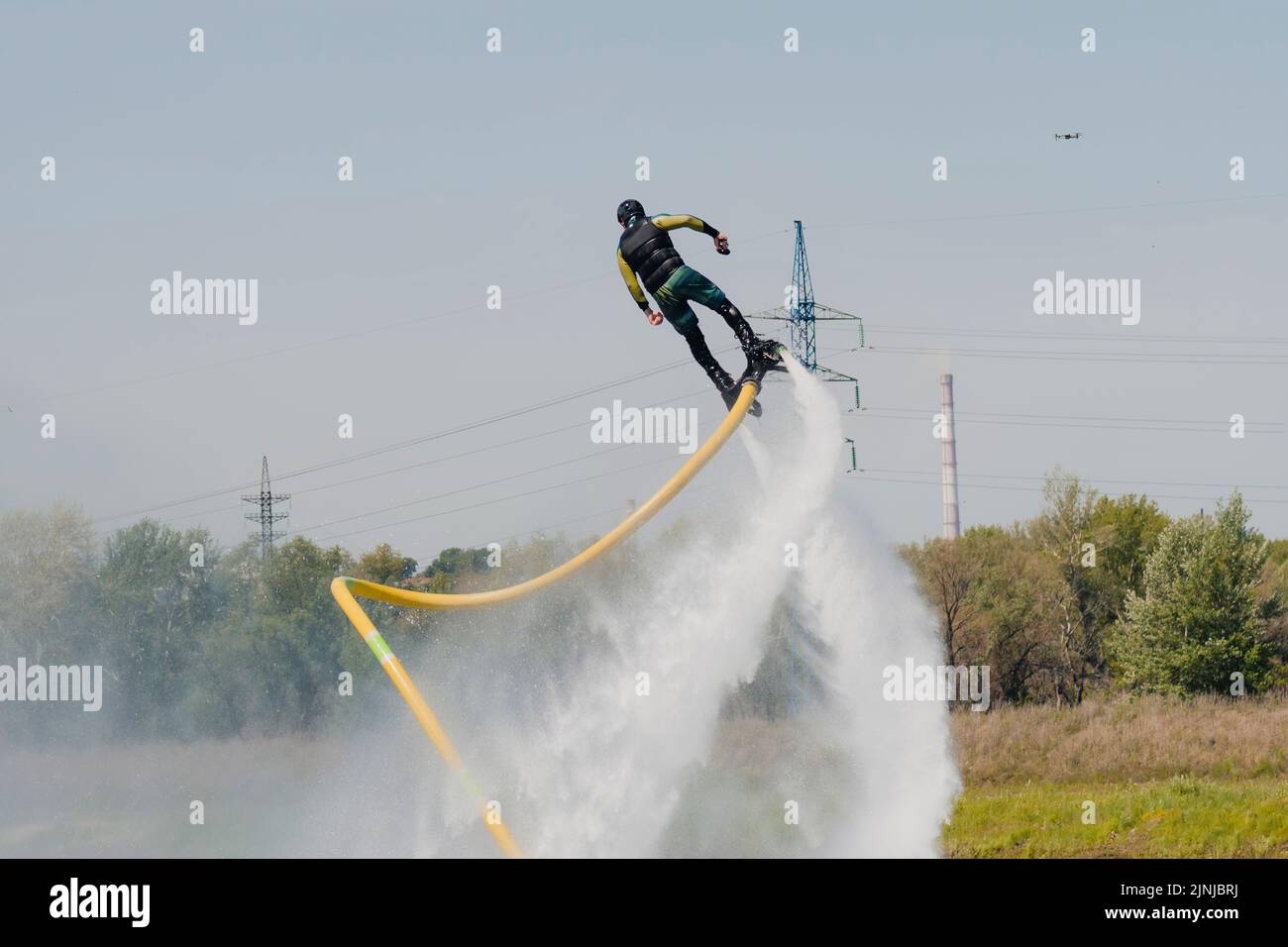 A man flies on a FlyBoard against the background of the sky. Extreme sport Stock Photo