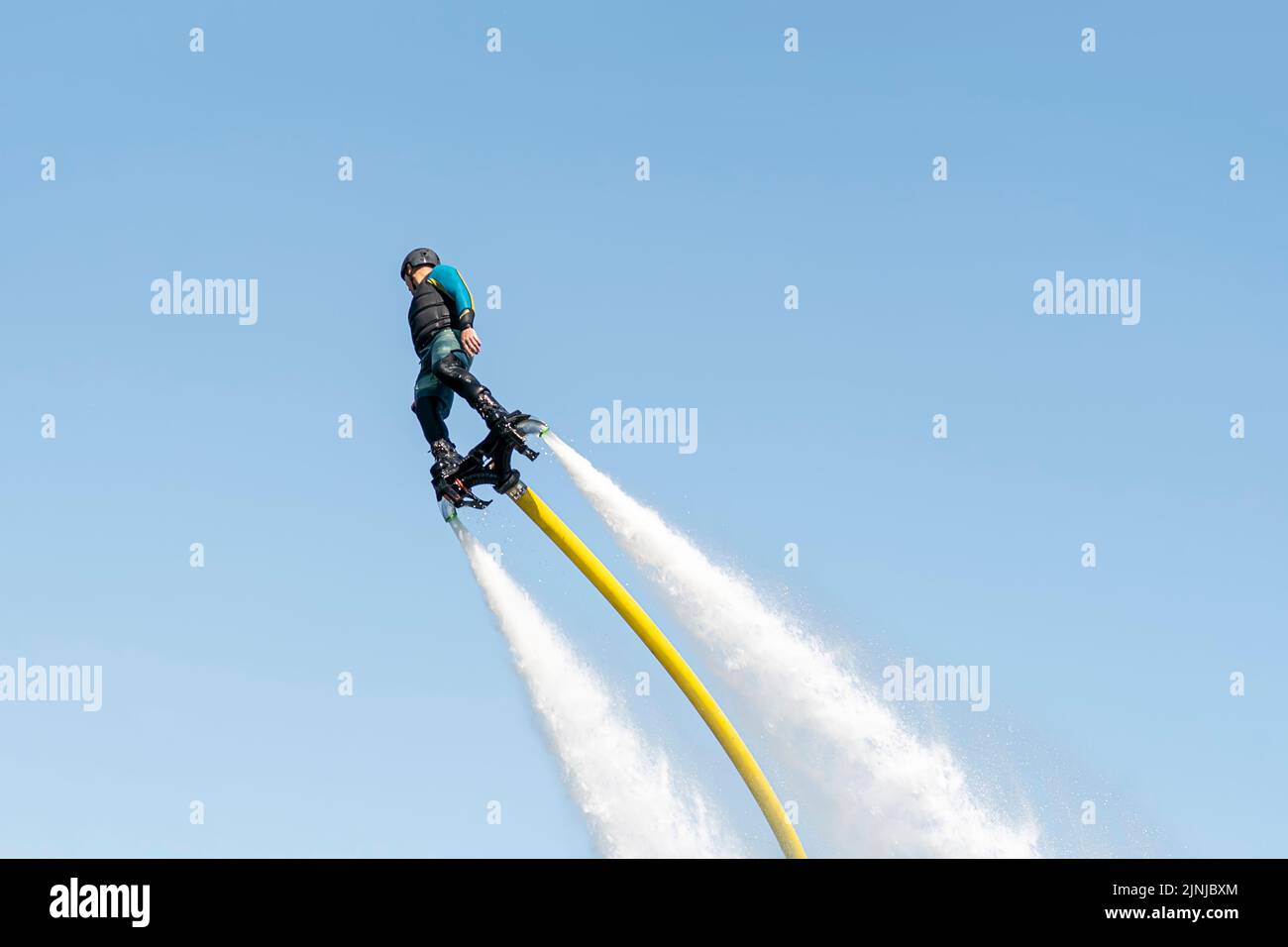 Flyboard. Air Farthest flight by hoverboard. Man flying on Board. Flyboard is aerial machine for personal watercraft, allows propulsion underwater Stock Photo