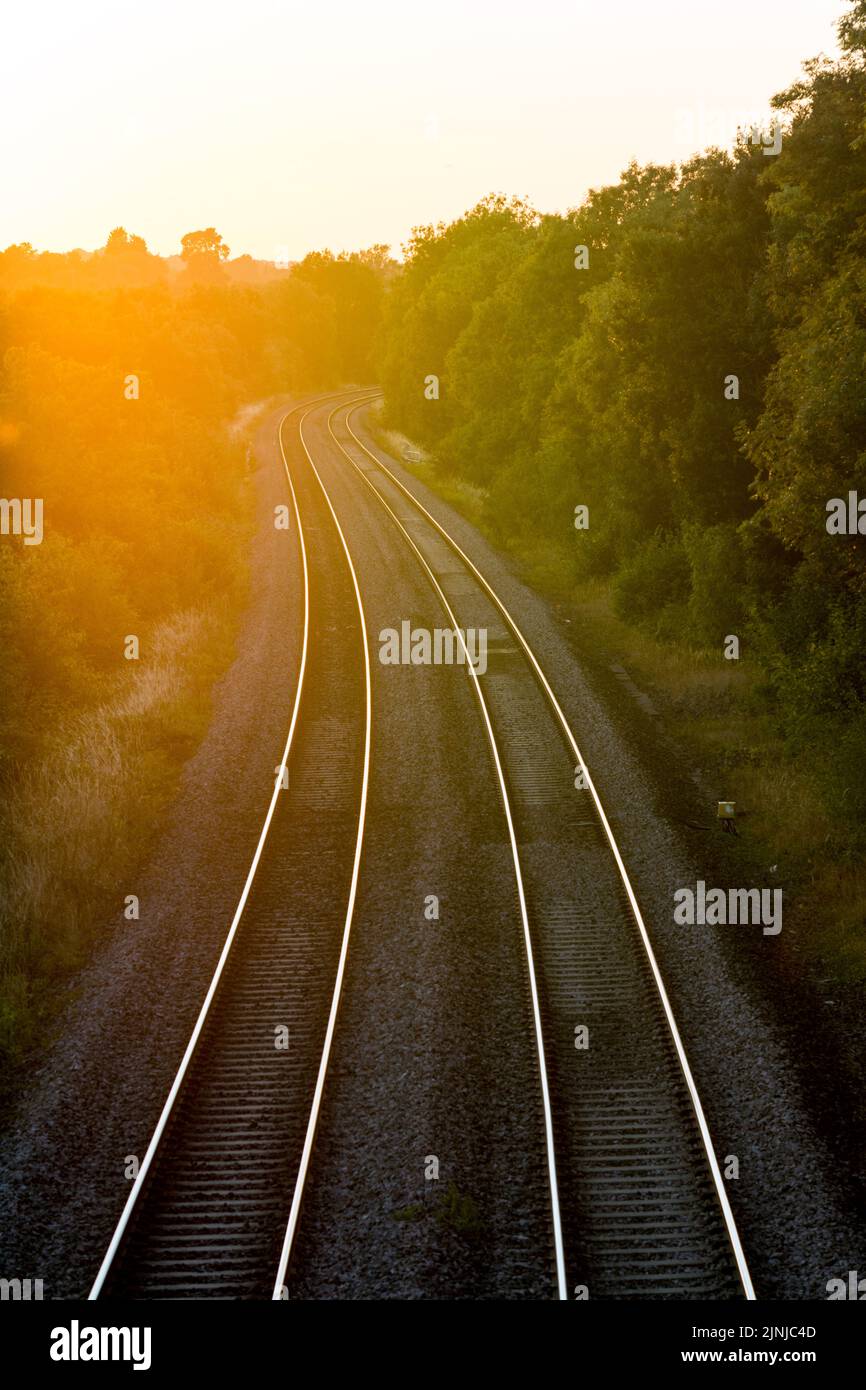 Railway lines at sunset in summer, Shrewley, Warwickshire, UK Stock Photo