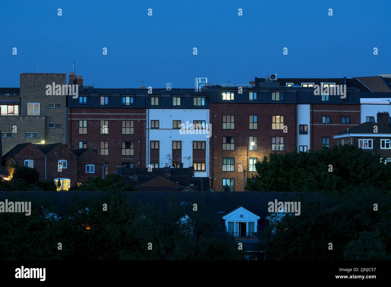 Apartment buildings at dusk in summer, Warwick town centre, Warwickshire, UK Stock Photo