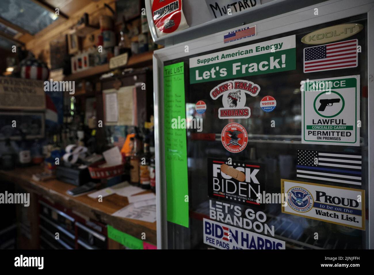 Stickers are posted on a refrigerator door with other memorabilia at Sporty's Iron Duke Saloon in Minerva, New York, U.S., July 20, 2022. REUTERS/Shannon Stapleton Stock Photo