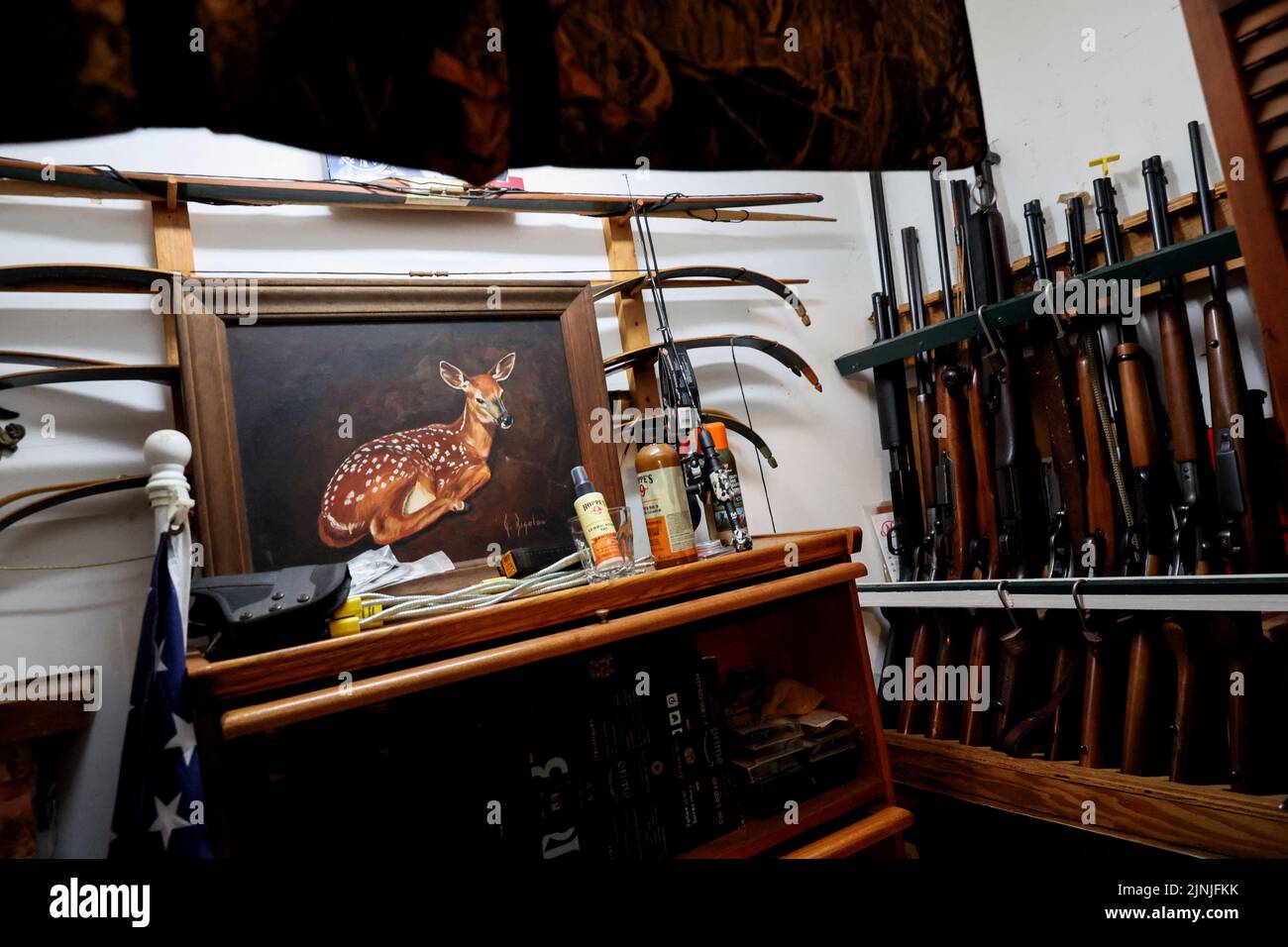 Rifles and bows stand in a gun rack inside a residents home in Corinth, New York, U.S., July 21, 2022. REUTERS/Shannon Stapleton Stock Photo