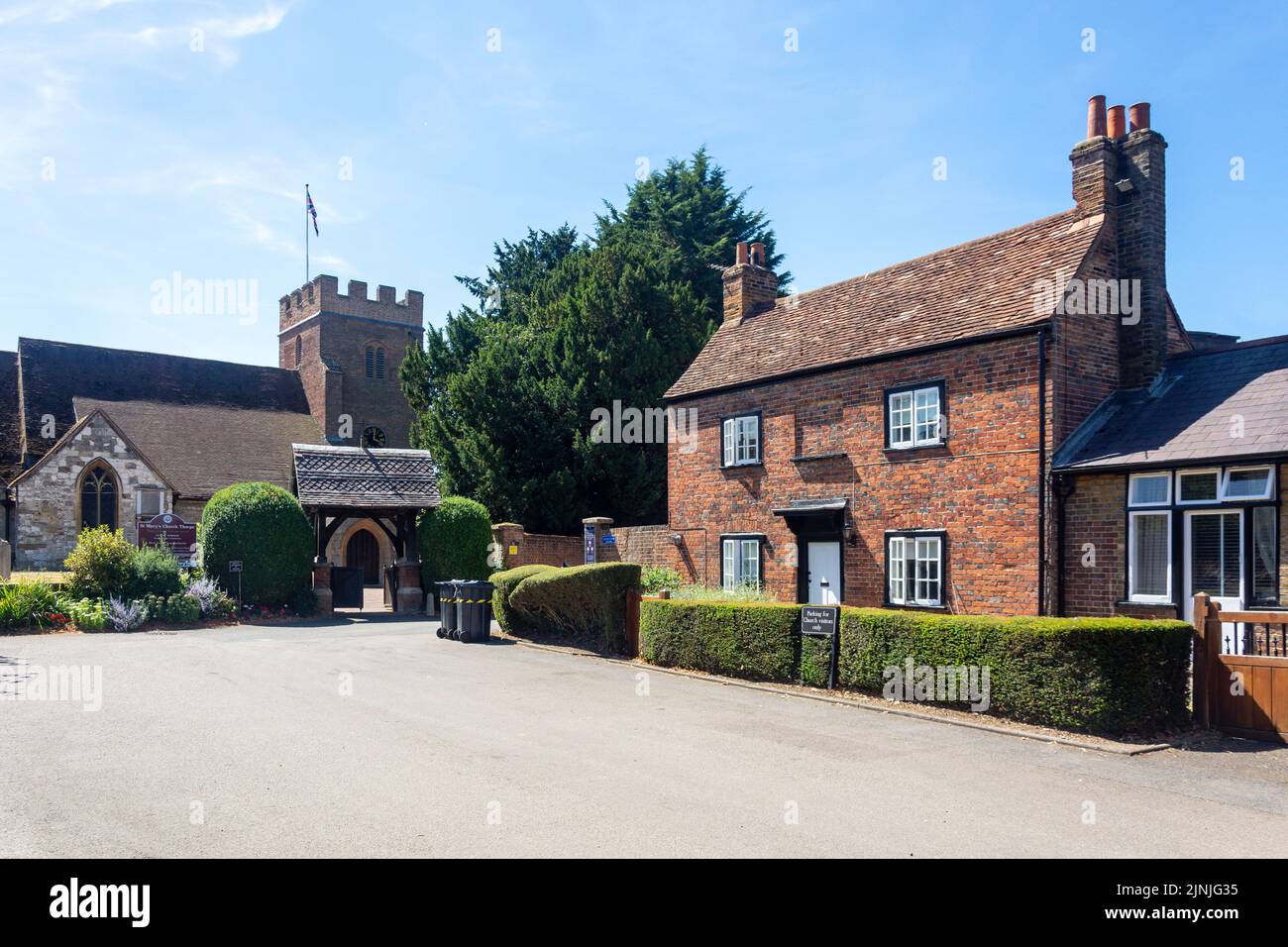 St Mary's Church and period cottage, Church Approach, Thorpe, Surrey, England, United Kingdom Stock Photo