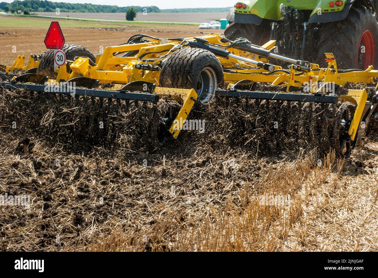 multidisc cultivator, tillage system in operation with tractor Stock