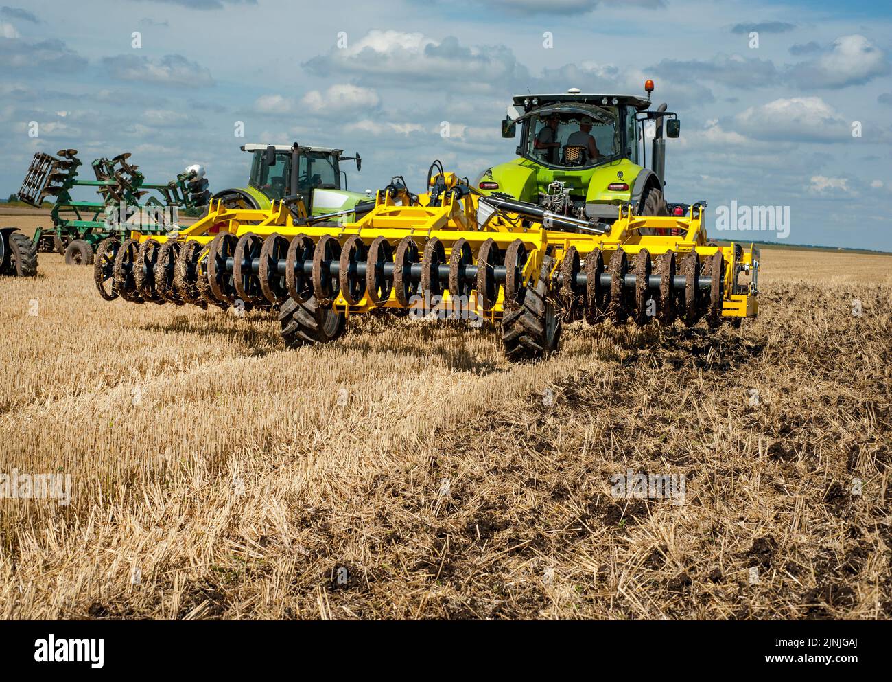 multidisc cultivator, tillage system in operation with tractor Stock