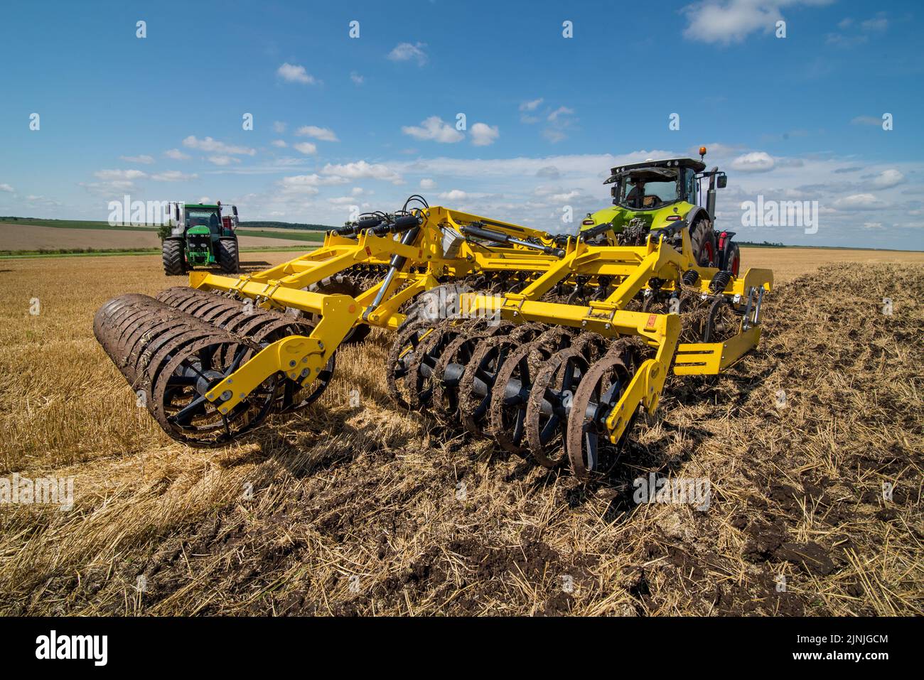 multidisc cultivator, tillage system in operation with tractor Stock