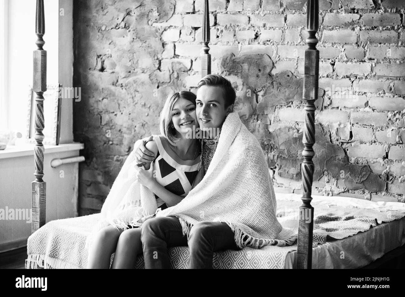 Love story of young happy, funny couple in studio, cozy home. Family holiday and togetherness, date. Stock Photo