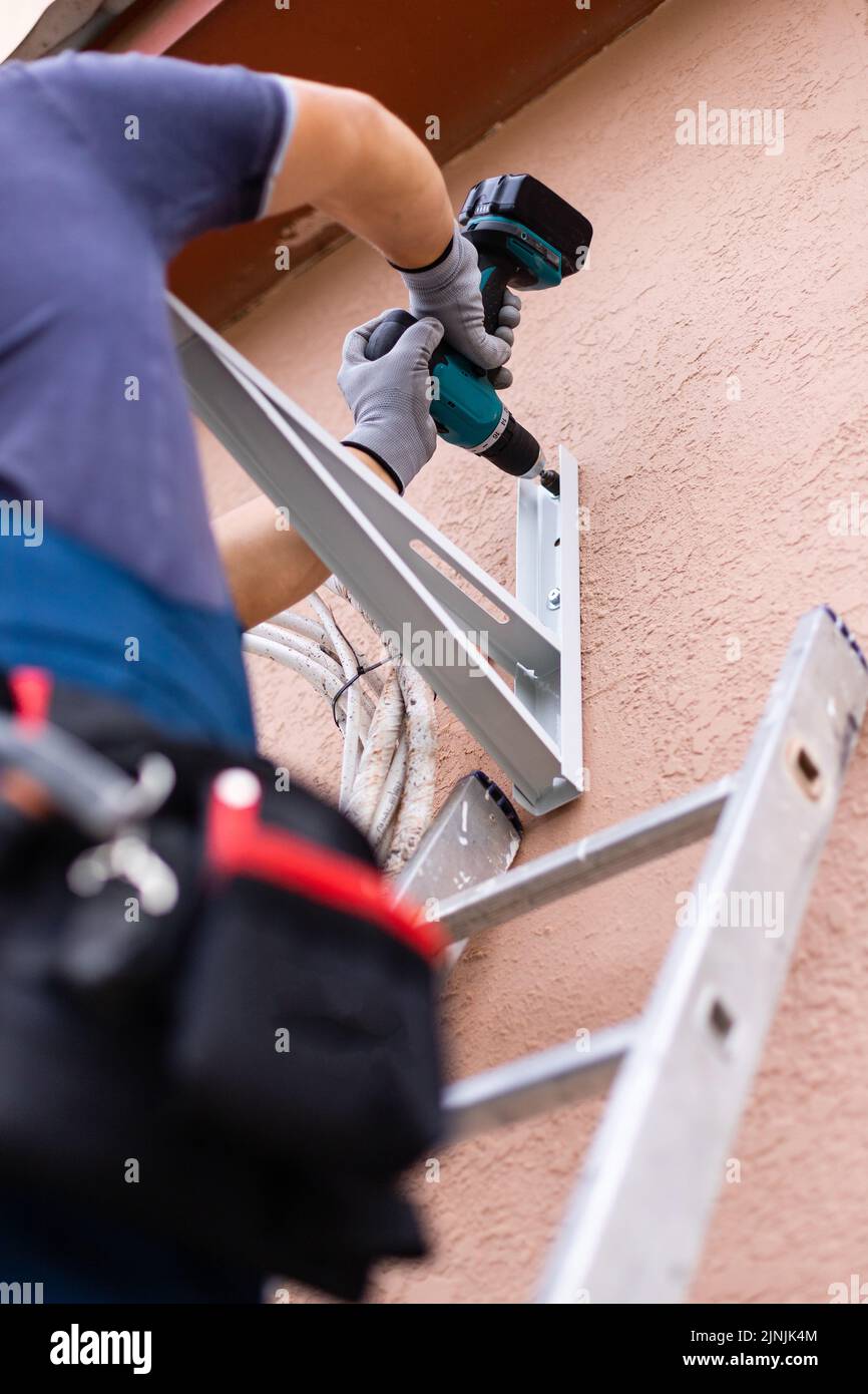 Installation of external block of conditioner by means of drill for