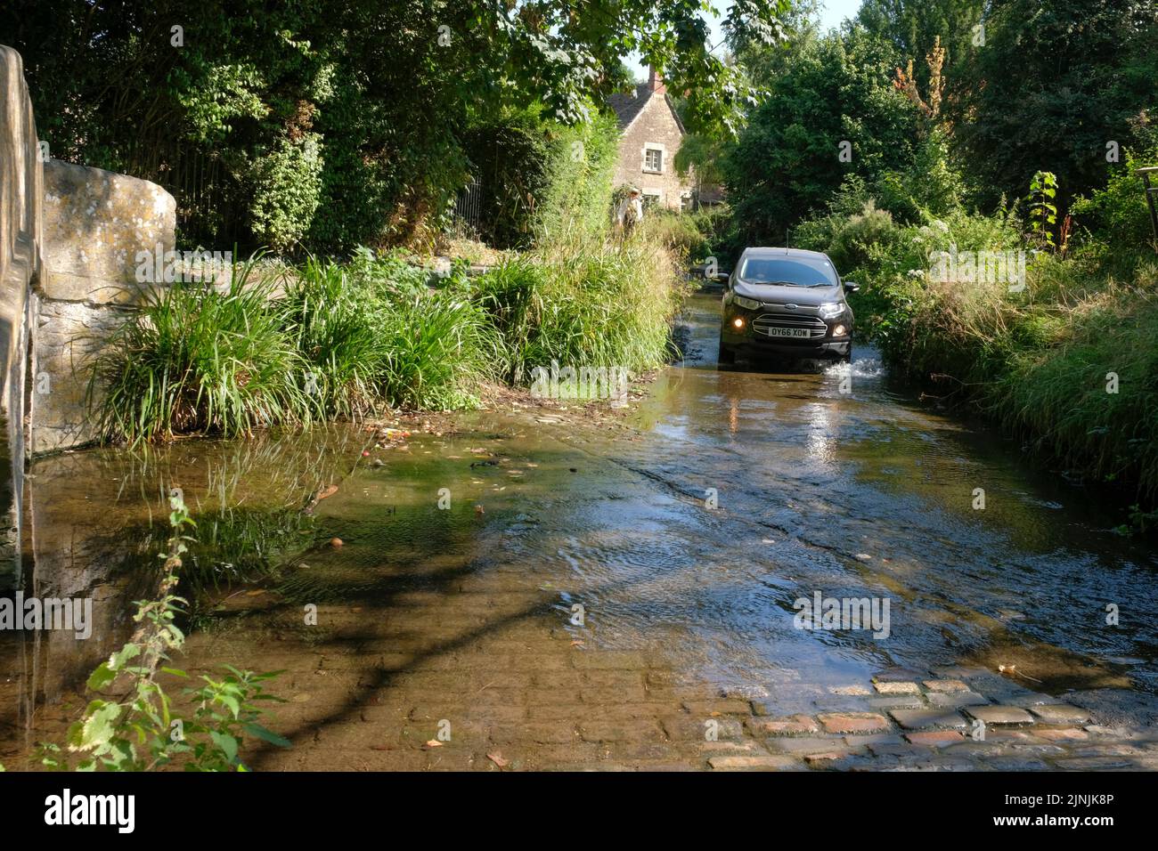 Lacock, UK. 12th Aug, 2022. Bide Brook in Lacock is normally a burbling little stream, today it is a shadow of its normal self. Stock Photo