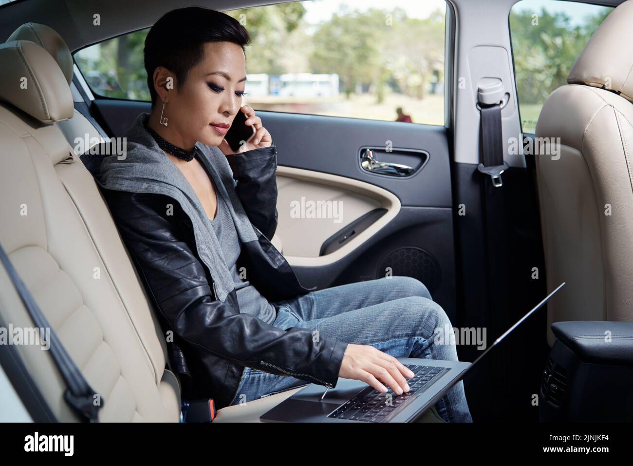 Asian woman in leather jacket hi-res stock photography and images - Alamy