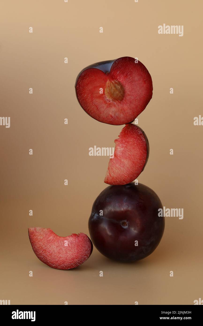 plums on the yellow background with copy space Stock Photo