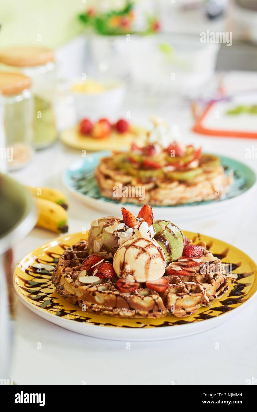 Delicious cooked waffle with ice-cream and fruits Stock Photo - Alamy