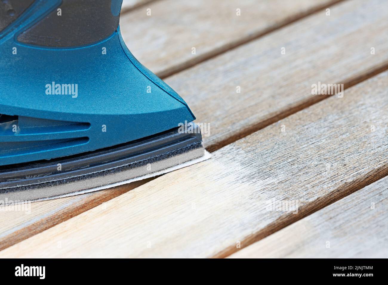 Sand down wooden furniture with a sanding machine Stock Photo