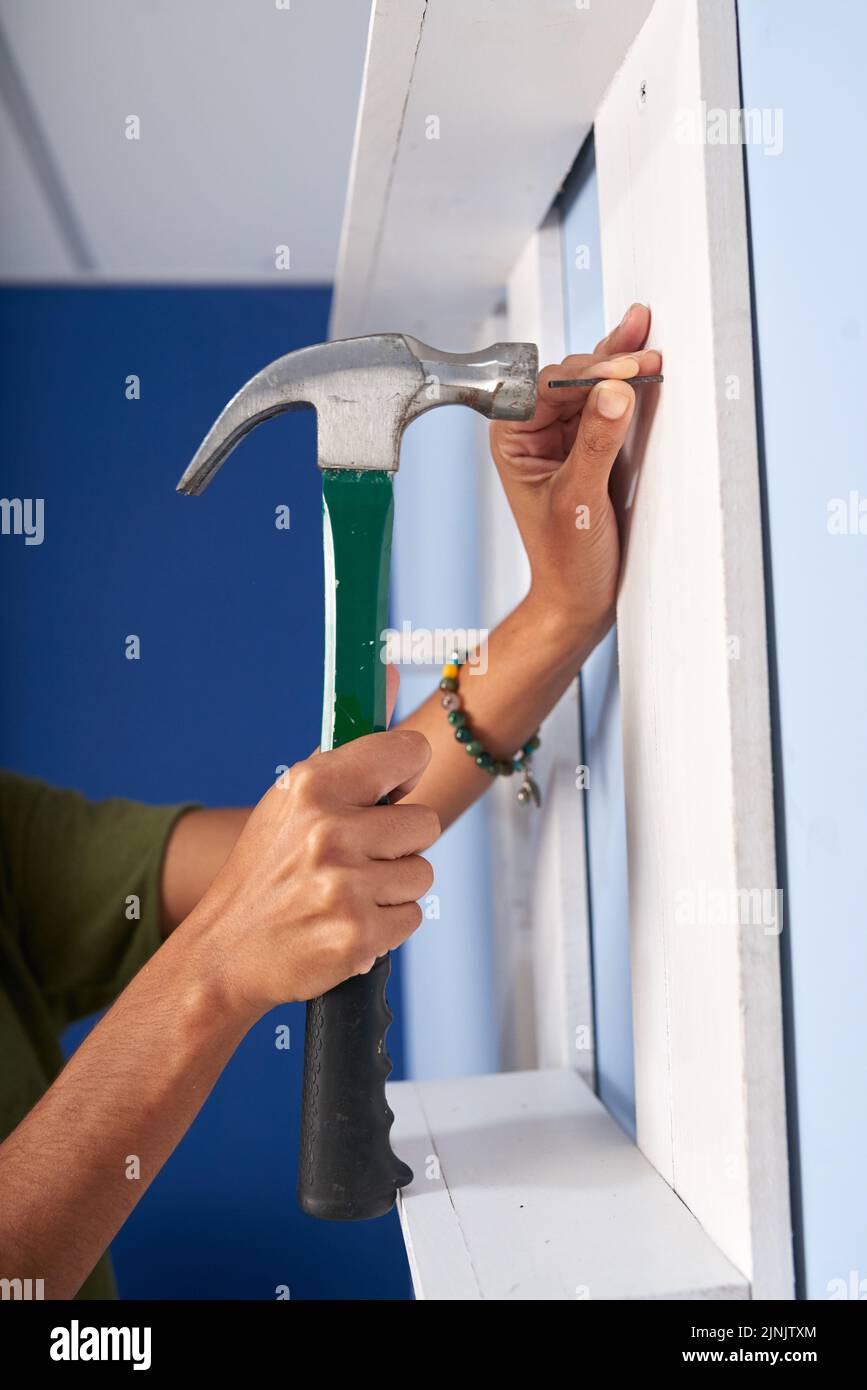 Woman hammering nail wall hi-res stock photography and images - Alamy Woman hammering nail wall hi-res stock photography and images - Alamy