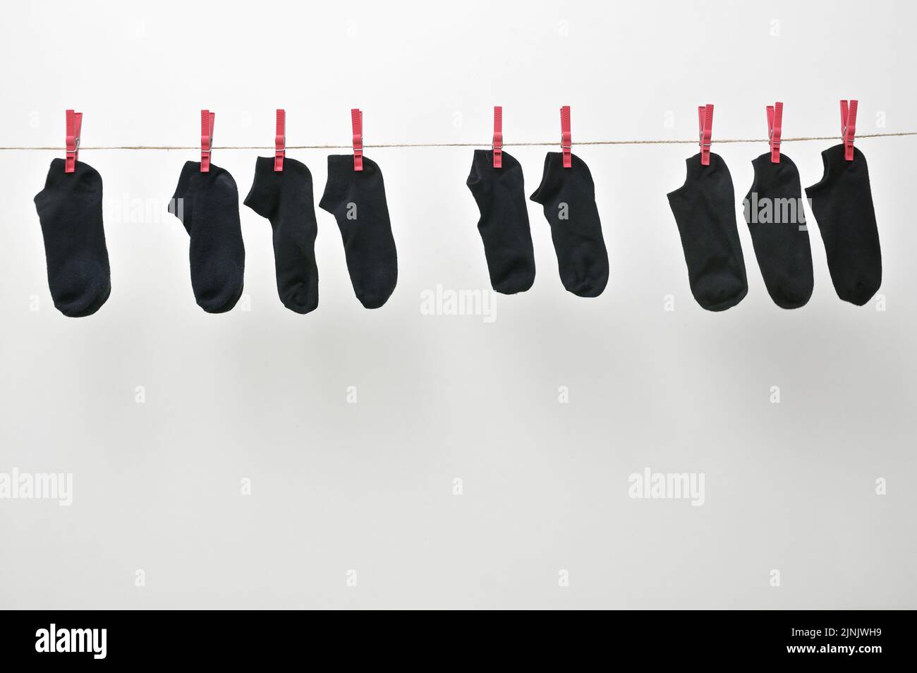 Piano Keyboard From Hanged Black Sock On The Clothesline With Clothespins Stock Photo