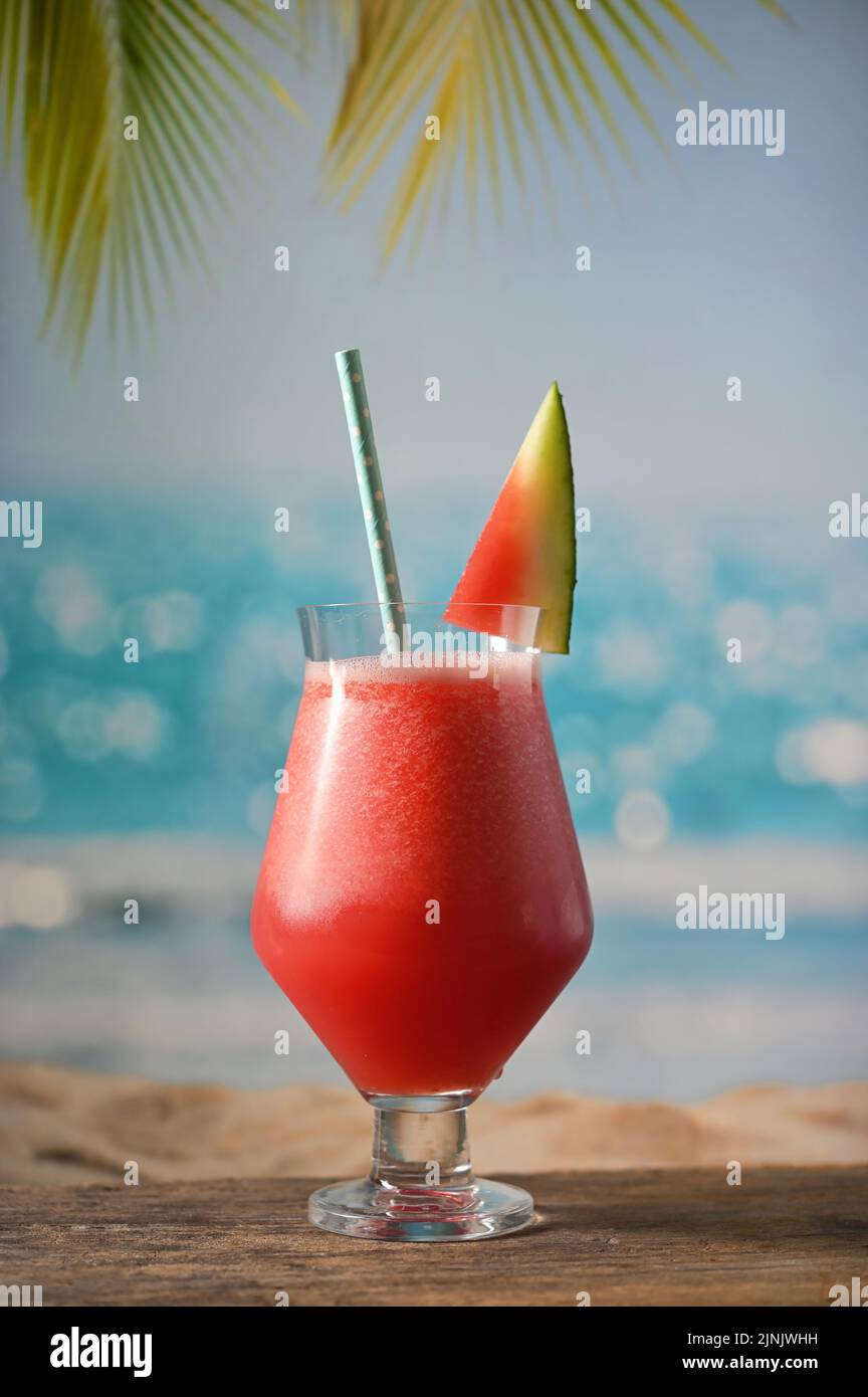 A Glass Of Freshly Squeezed Fresh Watermelon Juice on Beach Stock Photo