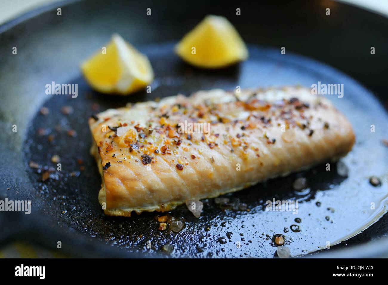 Roasted Salmon Fillet Steak In A Pan With Lemon Slices Stock Photo