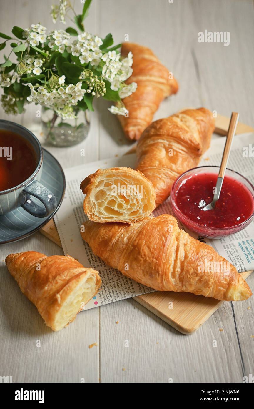 Closeup Table with Fresh baked croissant and tea Stock Photo
