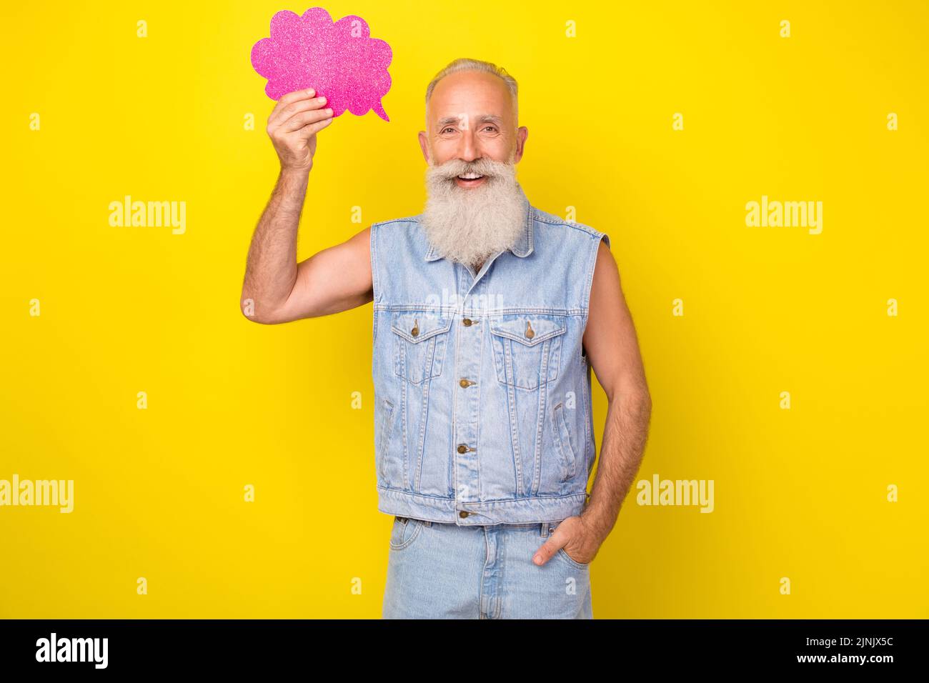 Photo of sweet thoughtful retired guy wear jeans waistcoat holding mind cloud empty space isolated yellow color background Stock Photo